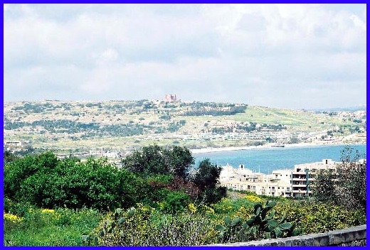 The view on the way from Mellieha Town to Mellieha Bay. The Red Tower can be seen in the background.